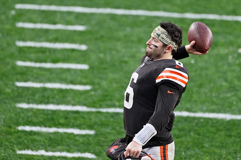 Cleveland Browns quarterback Baker Mayfield throws the game ball to a fan in the stands after the Browns defeated the Philadelphia Eagles in an NFL football game, Sunday, Nov. 22, 2020, in Cleveland. (AP Photo/Ron Schwane)