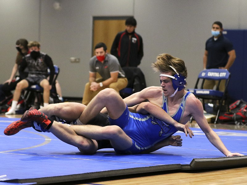 Capital City's Keaton Schrage tumbles out of bounds with Union's Wyatt Davis during their 145-pound matchup in Tuesday's dual at Capital City High School. 