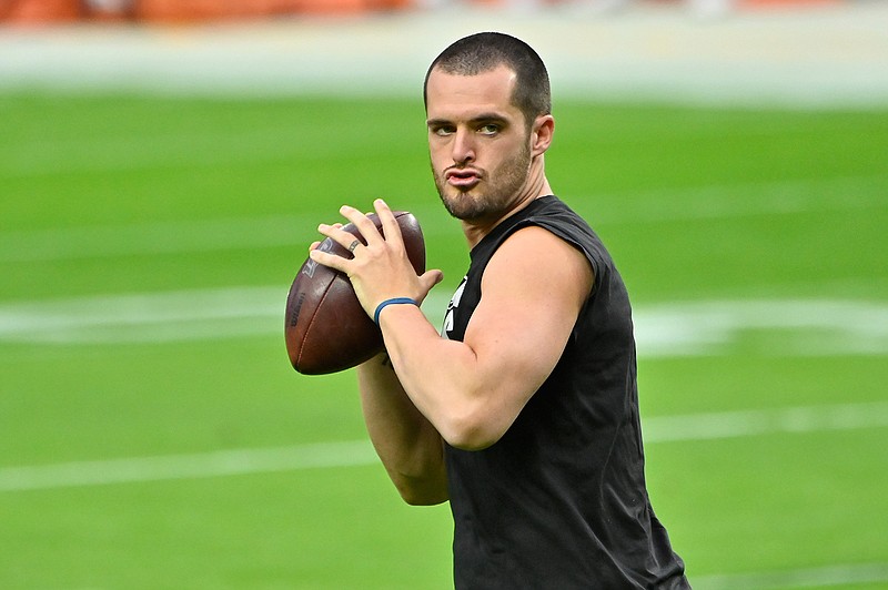 Las Vegas Raiders quarterback Derek Carr (4) warms before an NFL football game, Sunday against the Denver Broncos, Nov. 15, 2020, in Las Vegas. (AP Photo/David Becker)