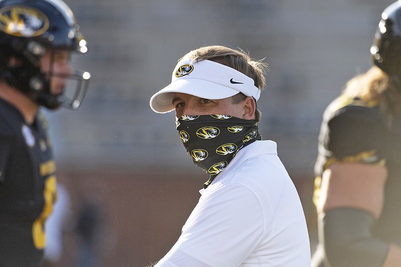 Missouri coach Eli Drinkwitz watches his team warm up prior to the start of a game against Alabama earlier this season at Faurot Field.