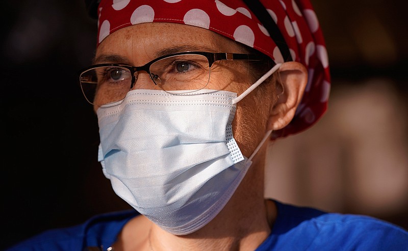 Nurse Teri Wheat poses for a photo in Fort Worth, Texas, Thursday, Nov. 19, 2020. As Wheat recently made her rounds at a Texas maternity ward, she began to realize she was having a hard time understanding the new mothers who were wearing masks due to the coronavirus pandemic. Hearing specialists across the U.S. say they have seen an uptick in visits from people like Wheat, who only realized how much they relied on lip reading and facial expressions when people started wearing masks that cover the nose and mouth.  (AP Photo/LM Otero)