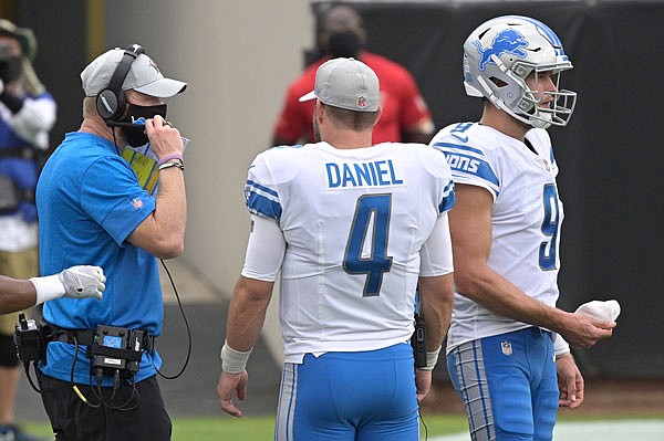 Lions offensive coordinator Darrell Bevell talks with quarterbacks Chase Daniel and Matthew Stafford during a timeout in a game last month against the Jaguars in Jacksonville, Fla.
