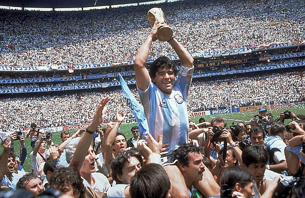 In this June 29, 1986 file photo, Diego Maradona holds up his team's trophy after Argentina's 3-2 victory against West Germany at the World Cup final soccer match at Azteca Stadium in Mexico City.