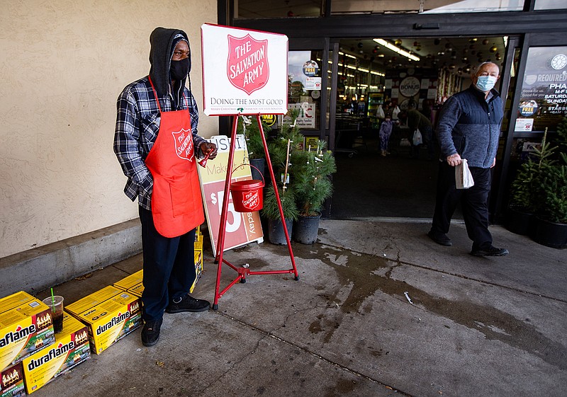 The Salvation Army's bell ringer Ivory Carter Sr. rings a bell to raise funds for The Salvation Army outside the Market Street store on 42nd Street Monday, Nov. 23, 2020, in Odessa, Texas.  (Jacob Ford/Odessa American via AP)