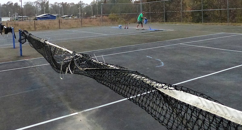  Way off in the distance, Tim Kennedy has begun pouring acrylic material on the Linden tennis courts.