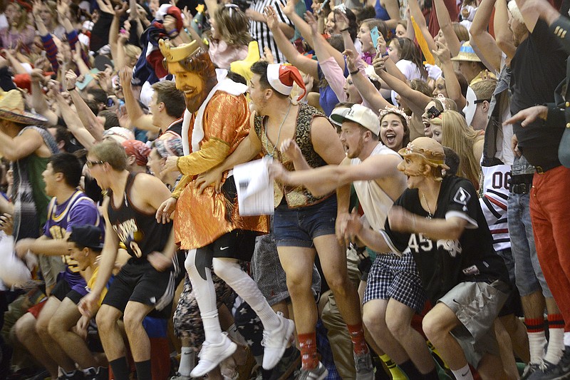In this Dec. 5, 2014, file photo, Taylor University students erupt with a roar as the Trojans score their 10th point against Kentucky Christian in the 18th annual Silent Night basketball game in Upland, Ind.