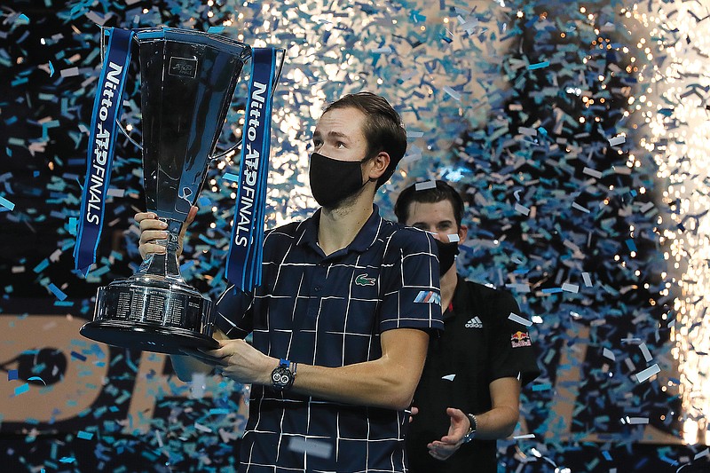 Daniil Medvedev holds the trophy Sunday as confetti falls after defeating Dominic Thiem in the championship match of the ATP World Finals in London.