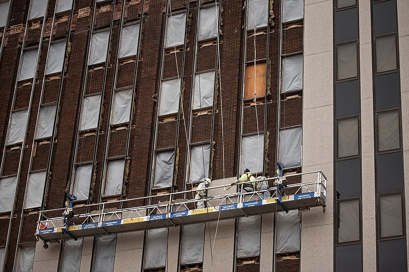 The facade of the former Texarkana National Bank building is being removed to uncover the original brick. The building is in the process of being restored and converted into an apartment complex called the Texarkanan.