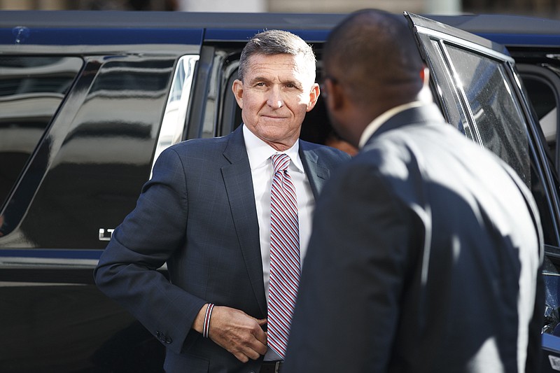 FILE - President Donald Trump's former National Security Advisor Michael Flynn arrives at federal court in Washington, Tuesday, Dec. 18, 2018. President Donald Trump has pardoned Michael Flynn, taking direct aim in the final days of his administration at a Russia investigation that he has long insisted was motivated by political bias. Trump announced the pardon on Wednesday, Nov. 25, 2020 calling it his “Great Honor.” (AP Photo/Carolyn Kaster)