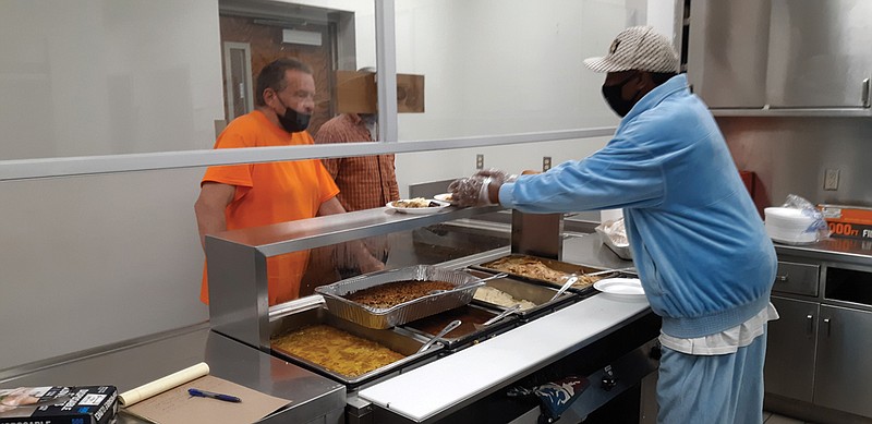 Lamont King, right, a veteran cook with Salvation Army-Texarkana, serves a Thanksgiving meal to the public. "I am humble and grateful to serve," he said. "I give thanks to God for having a chance to do his work."
