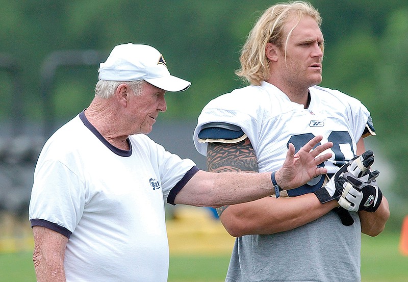 In this July 25, 2003, file photo, Rams offensive line coach Jim Hanifan works with Kyle Turley during training camp in Macomb, Ill.