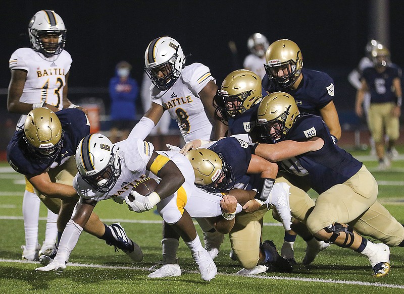 A host of Helias defenders bring down Rickie Dunn of Battle during a game this season at Ray Hentges Stadium.