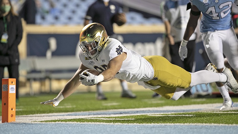 Notre Dame's George Takacs gets past North Carolina's Tyrone Hopper, picking up 13 yards on a pass completion from quarterback Ian Book and dives toward the goal line, but is stopped short during the fourth quarter of Friday's game in Chapel Hill, N.C.