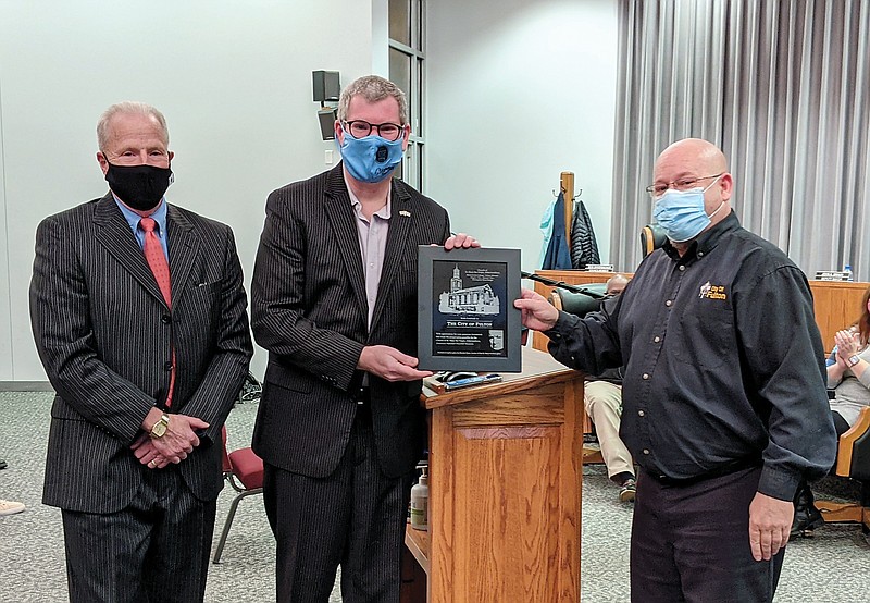 Don Lofe, left, Westminster College's interim president and chief transformation officer, and National Churchill Museum Curator and Director Tim Riley present Fulton Mayor Lowe Cannell with a plaque thanking the city for its aid in the museum's renovation efforts.