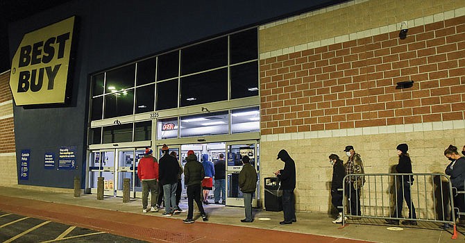 Black Friday shoppers wait outside Best Buy on Missouri Boulevard early Friday morning. The electronics store let 35 customers inside at a time to encourage social distancing.