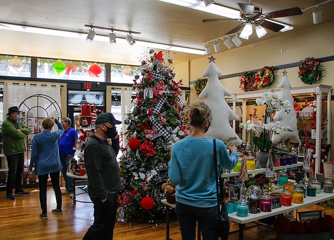 People peruse the many festive decorations at River City Florist on Small Business Saturday.