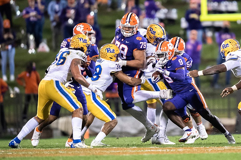 Clemson running back Travis Etienne (9) runs the ball during the third quarter of an NCAA college football game against Pittsburgh in Clemson, S.C., Saturday, Nov. 28, 2020. (Ken Ruinard/The Independent-Mail via AP, Pool)