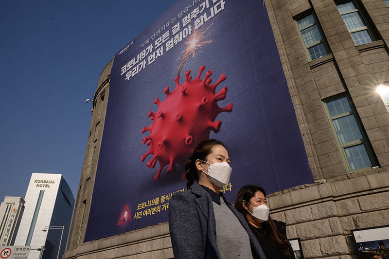 A poster warning against the covid-19 novel coronavirus is displayed in Seoul on November 26, 2020. - South Korea reported its highest daily number of coronavirus cases since March on November 26, with a surge of new infections sparking fears of a major third wave. (Photo by ED JONES/AFP via Getty Images/TNS)