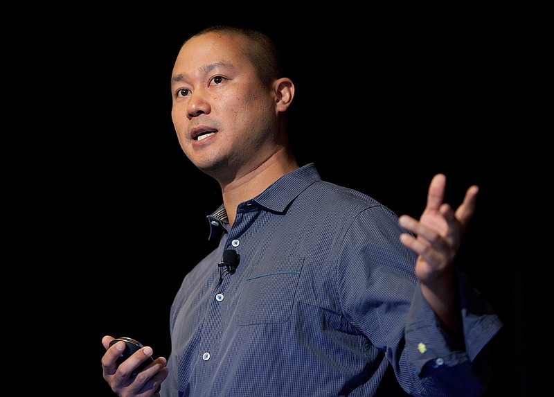 FILE - In this Sept. 30, 2013, file photo, Tony Hsieh speaks during a Grand Rapids Economic Club luncheon in Grand Rapids, Mich. Hsieh, retired CEO of Las Vegas-based online shoe retailer Zappos.com, has died. Hsieh was with family when he died Friday, Nov. 27, 2020, according to a statement from DTP Companies, which he founded. Downtown Partnership spokesperson Megan Fazio says Hsieh passed away in Connecticut, KLAS-TV reported. Hsieh recently retired from Zappos after 20 years leading the company. He worked to revitalize the Las Vegas area. (Cory Morse/The Grand Rapids Press via AP, File)