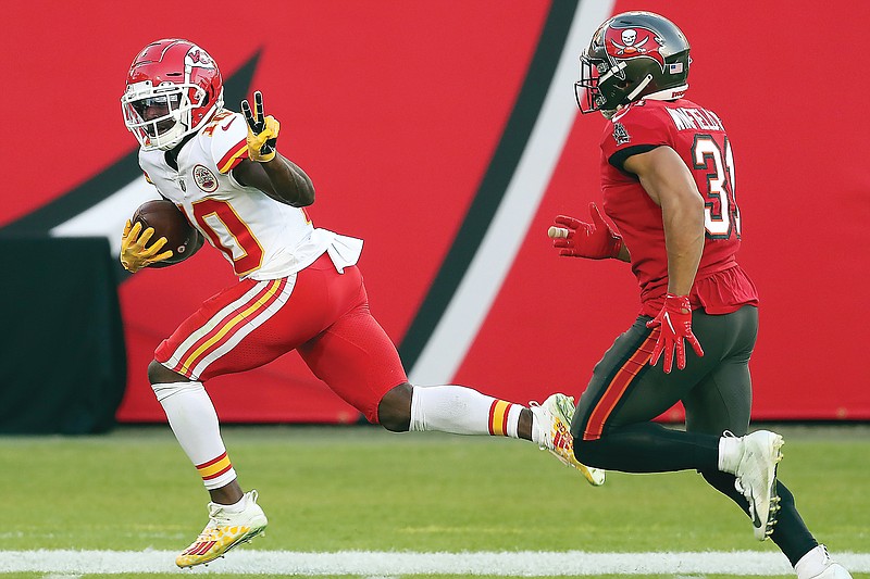 Chiefs wide receiver Tyreek Hill sprints past Buccaneers strong safety Antoine Winfield Jr. on his way to a 75-yard touchdown reception during the first half of Sunday's game in Tampa Fla.