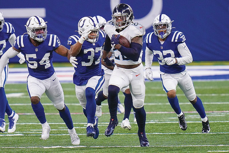 Titans running back Derrick Henry sprints away from Colts defenders during Sunday afternoon's game in Indianapolis.