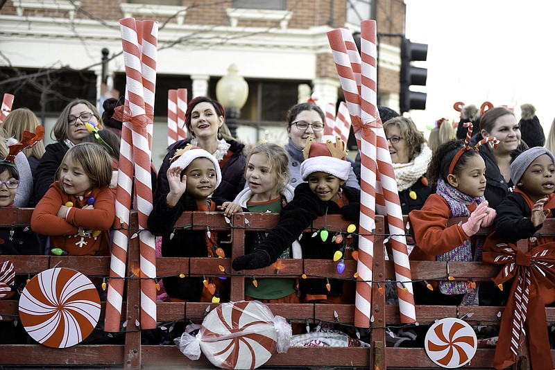 Children wave from atop a candy cane float at the 80th annual Jefferson City Jaycees Candyland Christmas Parade in 2019. 