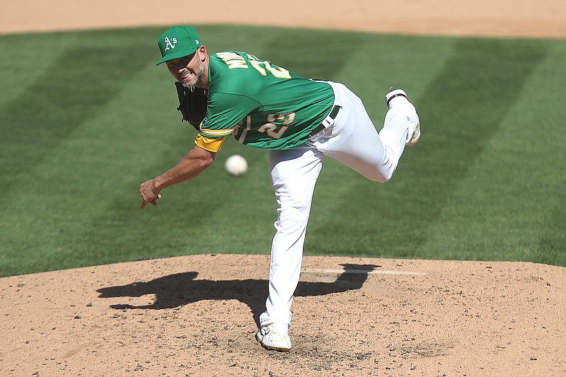 Mike Minor pitches for the Athletics during a game last season against the Mariners in Oakland, Calif.