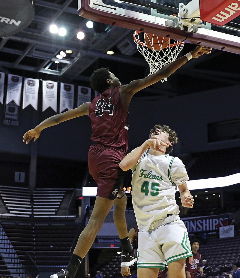 Blair Oaks' Luke Northweather watches his shot go through the hoop as Cardinal Ritter's Brandon Ellington jumps up for a block attempt during a Class 3 semifinal game last season at JQH Arena in Springfield. Northweather is one of three returning starters for the Falcons this season.