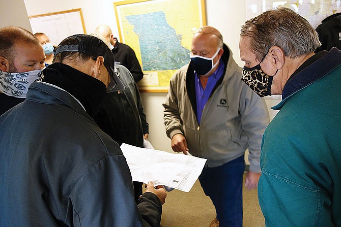 Subcontractors look over plans Thursday for part of Callaway County's new jail during a pre-bid meeting.