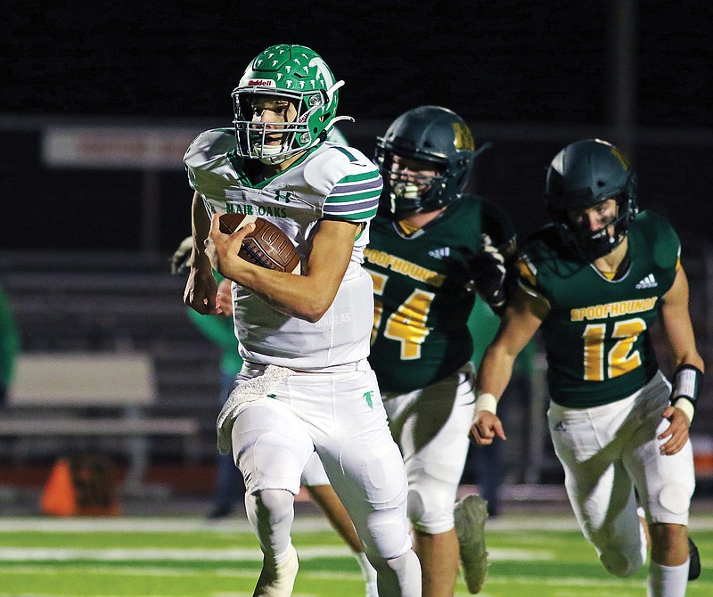 Blair Oaks quarterback Dylan Hair breaks free for a long run as Maryville's Dylan White (54) and Cooper Loe trail on the play Saturday night during the Class 3 state championship game at Adkins Stadium.