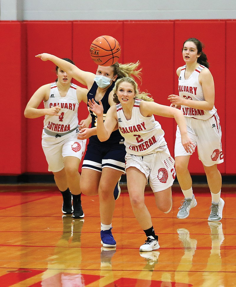 Calvary Lutheran's Chloe Baker steals the ball away from Columbia Independent's Molly Angell during Tuesday night's game at Calvary Lutheran.