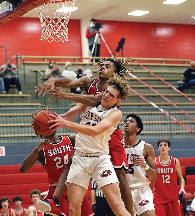 Jefferson City forward Cole Heller grabs a rebound in front of Fort Zumwalt South's Nihlan Harris during Friday night's game at Fleming Fieldhouse.