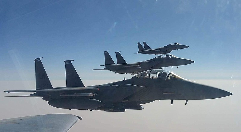 <p>BELOW: Cole Stegeman pilots an F-15E, foreground, over Syrian airspace during a mission in 2017.</p>