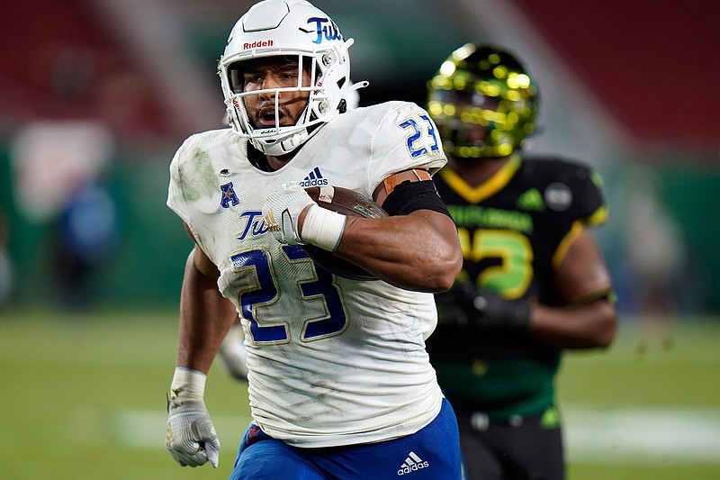Tulsa linebacker Zaven Collins (23) runs back an interception for a score against South Florida during the second half of an NCAA college football game in Tampa, Fla., in this Friday, Oct. 23, 2020, file photo. Zaven Collins is a small-town player with big-time talent. He was overlooked after a stellar high school career in Hominy, Okla., a town with about 3,500 people. He's got the nation's attention now -- the 6-foot-4, 260-pound linebacker is a finalist for the Butkus and Nagurski Awards. (AP Photo/Chris O'Meara, File)