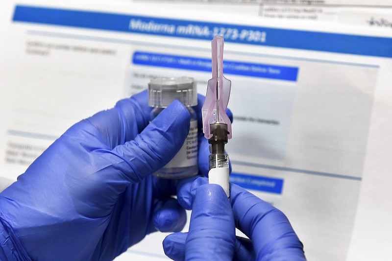 FILE - In this July 27, 2020, file photo, a nurse prepares a shot as a study of a possible COVID-19 vaccine, developed by the National Institutes of Health and Moderna Inc., gets underway in Binghamton, N.Y. The U.S. is poised to give the green light as early as Friday, Dec. 18, to a second COVID-19 vaccine, a critical new weapon against the surging coronavirus. Doses of the vaccine developed by Moderna Inc. and the National Institutes of Health will give a much-needed boost to supplies as the biggest vaccination effort in the nation’s history continues. (AP Photo/Hans Pennink, File)
