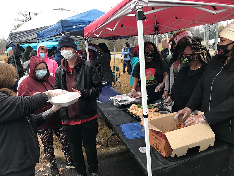 Nearly 200 local and area needy residents gather late Saturday morning in a parking lot behind the Texarkana Public Library for the second annual Community Feed Holiday event. More than a dozen local and area motorcycle clubs and social clubs organized and put on the charity.