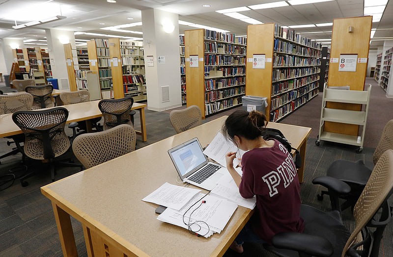 A student works in the library June 20, 2019, at Virginia Commonwealth University in Richmond, Va. Talk of student loan forgiveness has borrowers looking forward to 2021.