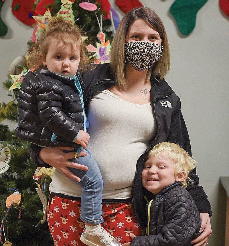 Jade Sanders standsThursday with her children Phoenix, 1, left, and Hudson, 4 in the lobby of Little Explorers Discovery Center. Sanders, who also attended the Center as a child, has not only seen growth in her children's education, but also understanding and support from its staff.