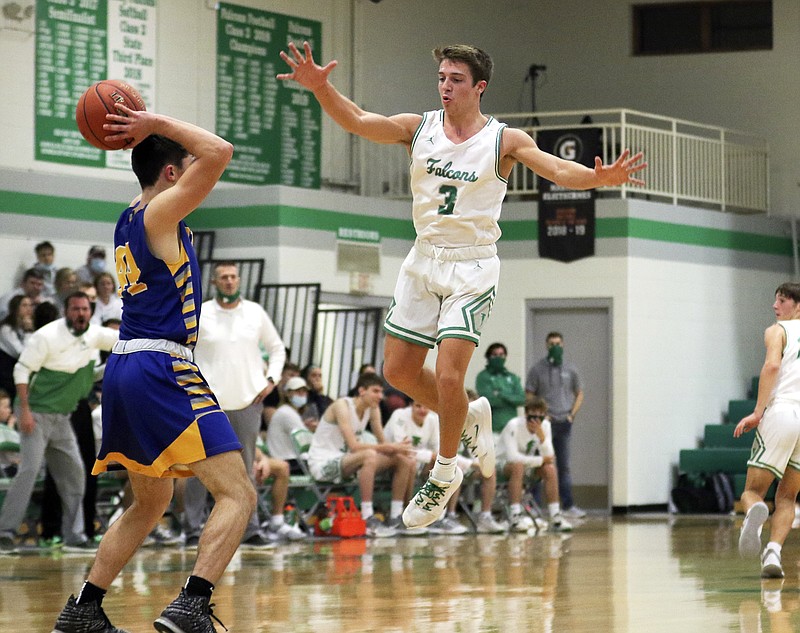 Jake Closser of Blair Oaks leaps to try to block a pass by Fatima's Jacob Vanderfeltz during Tuesday night's game in Wardsville.