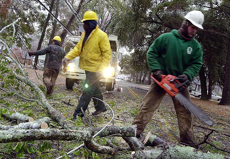 City work crews clear roads of downed limbs and utility lines Christmas morning of 2000. The ice storm didn't look so bad that morning, but worse was to come. (Texarkana Gazette file photo)
