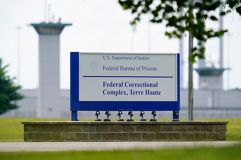 This Aug. 28, 2020, file photo shows the federal prison complex in Terre Haute, Ind. A federal judge said the Justice Department unlawfully rescheduled the execution of the only woman on federal death row, potentially setting up the Trump administration to schedule the execution after president-elect Joe Biden takes office. U.S. District Court Judge Randolph Moss also vacated an order from the director of the Bureau of Prisons that had set Lisa Montgomery's execution date for Jan. 12, 2021.  (AP Photo/Michael Conroy)