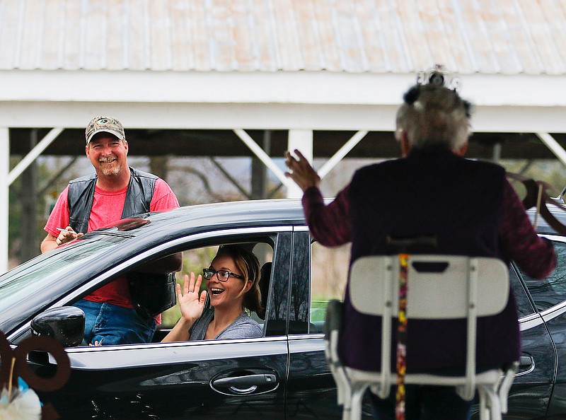 Elyse and Joe Wyckoff wave at their grandmother, Lois Bess, during Bess' surprise birthday caravan in March 2020 celebrating her 90th birthday at the Tebbetts Community Center.