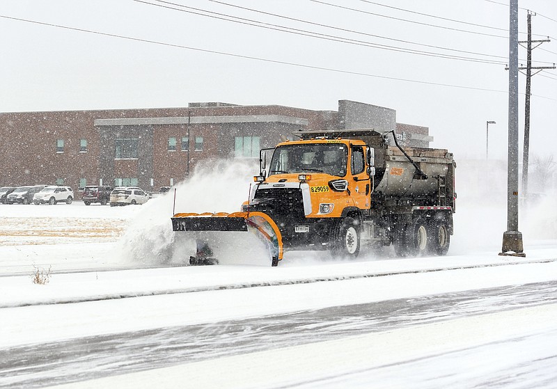 A snow plow clears off Cliff Avenue during a winter storm Tuesday in Sioux Falls, South Dakota. (Erin Bormett/The Argus Leader via AP)