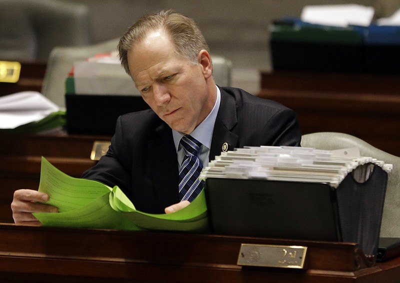 FILE- In this Thursday, March 31, 2016 file photo, Missouri state Sen. Bob Onder, R-Lake Saint Louis, works at his desk in the Senate chamber in Jefferson City. (AP Photo/Jeff Roberson, File)