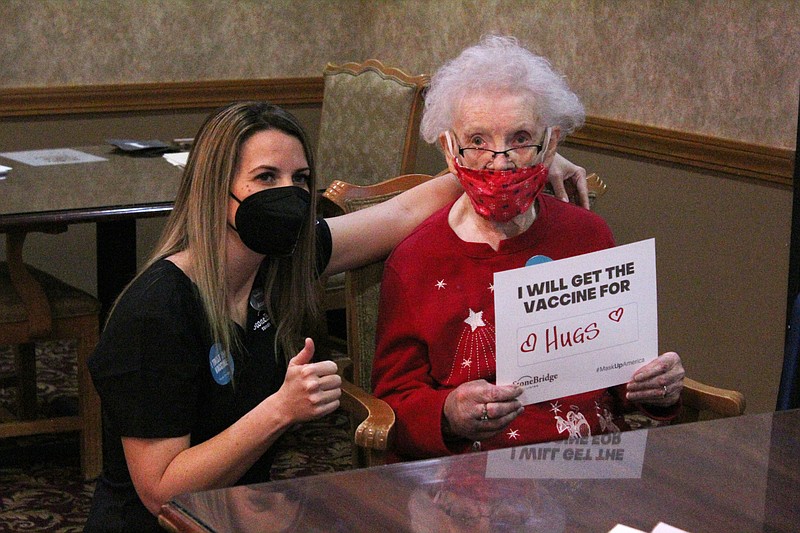 Amanda Cross, regional nurse for StoneBridge Senior Living, left, smiles behind a mask next to StoneBridge Senior Living Lake Ozark resident Ethel Otto, 101, who received a COVID-19 vaccination Wednesday, Dec. 30, 2020.