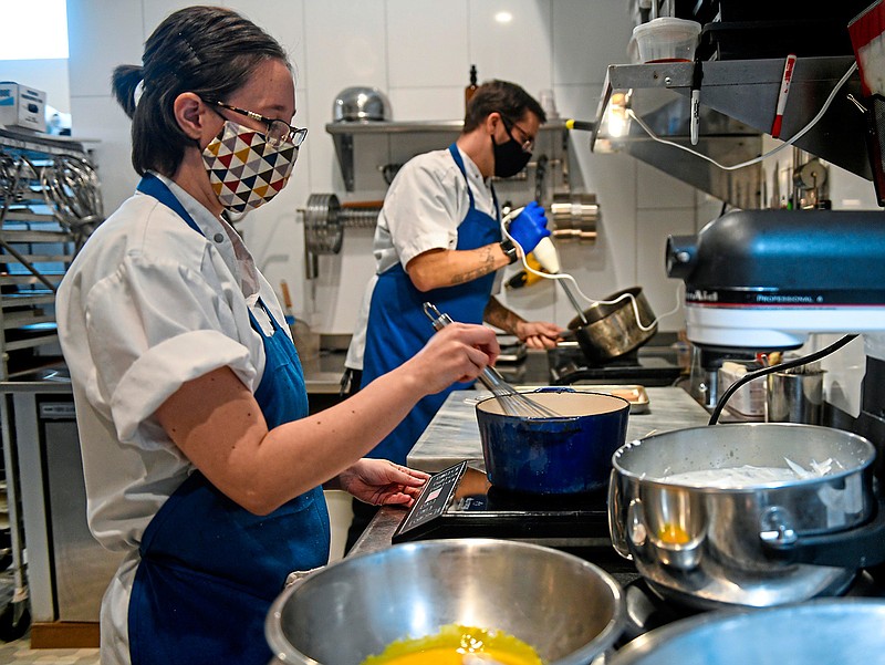 Lisa Wilson, left, sous chef, and Adam Bates, chef and owner of Harrison's Fine Pastries in East Liberty, create European-style desserts on Monday, Dec. 7, 2020. (Steve Mellon/Post-Gazette/TNS)