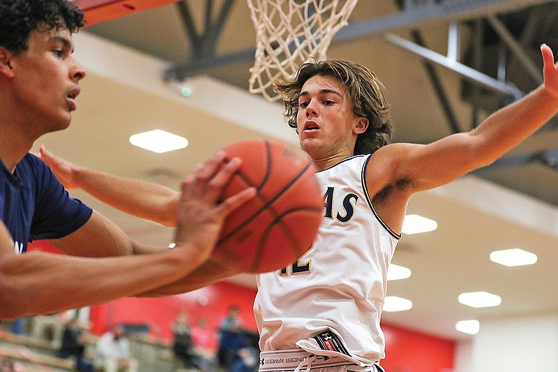 Helias guard Joe Rembecki jumps up to try and block an in-bounds pass from Father Tolton forward Jevon Porter during Tuesday's game in the Joe Machens Fantastic Four Tournament at Fleming Fieldhouse.