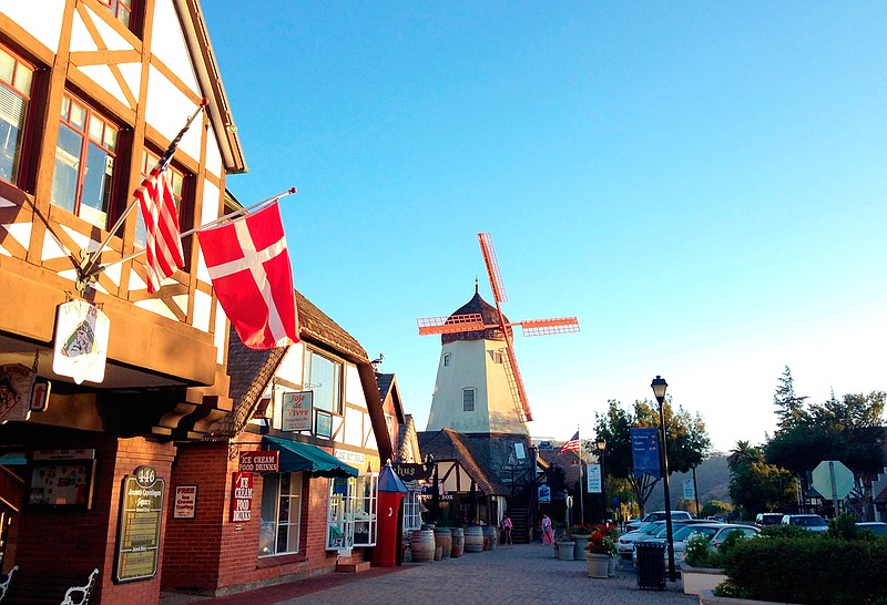 This Sept. 30, 2014 photo shows the Danish flag flying on Alisal Road in Solvang, Calif., on Sept. 30, 2014.  Founded in 1911 by Danish immigrants, Solvang is a touristy enclave with Danish bakeries, Danish-themed hotels and even a Hans Christian Andersen Museum. The location is featured in a collection of mini-essays by American writers published online by the Frommer's guidebook company about places they believe helped shape and define America.  (AP Photo/Solvej Schou, File)