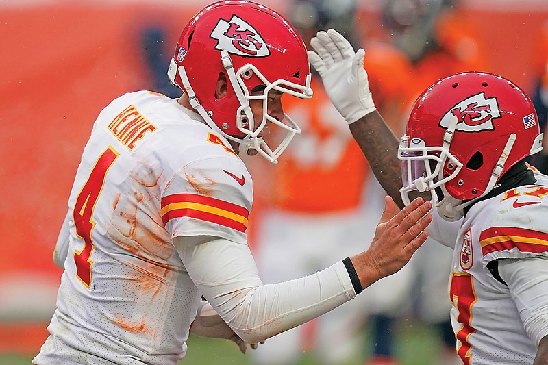 Chiefs quarterback Chad Henne celebrates after scoring a touchdown during the second half of a game against the Broncos earlier this season in Denver. 