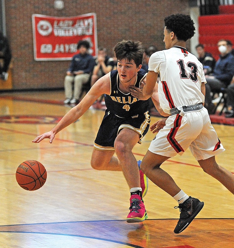 Malcolm Davis of Helias attempts to dribble around Koby Sands of Jefferson City on Friday during the Joe Machens Fantastic Four Tournament at Fleming Fieldhouse. 